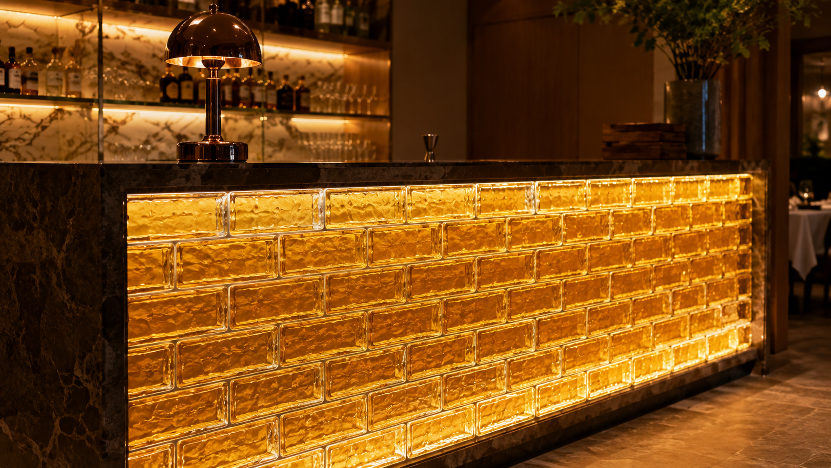 Illuminated hollow glass brick wall with warm LED lighting at night