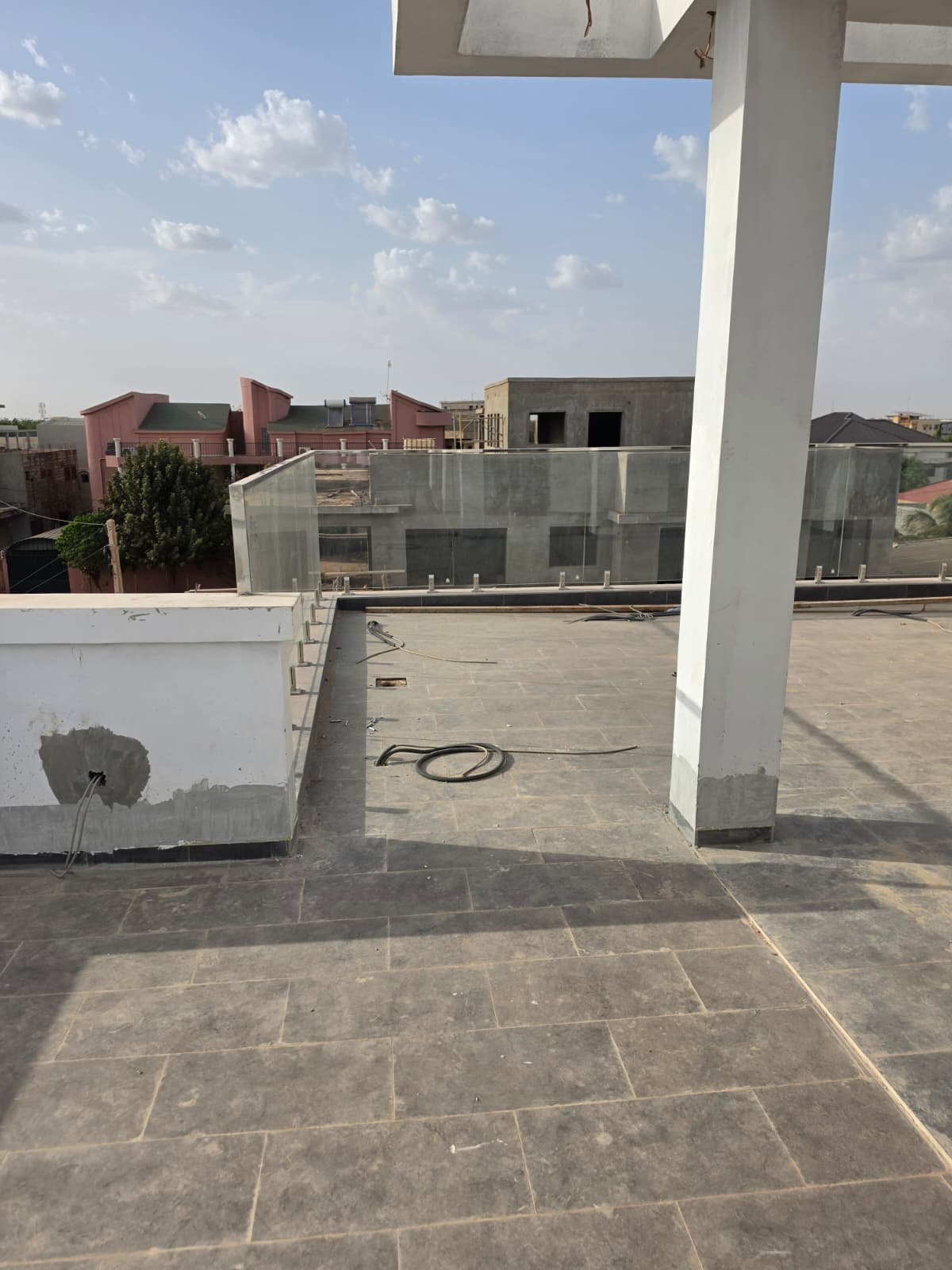 Laminated glass railing installed on rooftop terrace in Burkina Faso.jpg